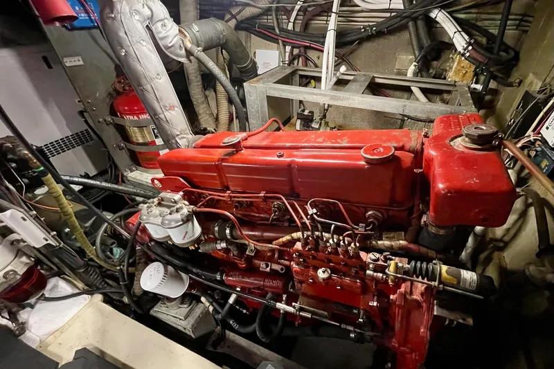 Freedom Yacht Photos Pics Engine room of a 1976 Hatteras 48 Long Range Cruiser with red machinery.