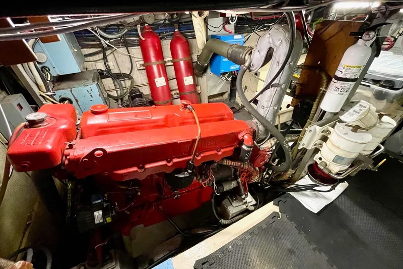 Freedom Yacht Photos Pics Engine room of a 1976 Hatteras 48 Long Range Cruiser with red diesel engine.