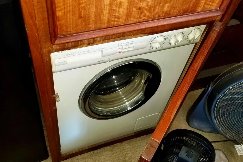 Freedom Yacht Photos Pics Washer-dryer unit in 1976 Hatteras 48 Long Range Cruiser, wooden cabinetry.