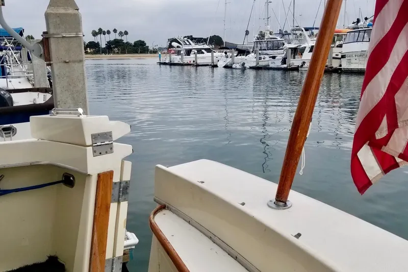Freedom Yacht Photos Pics 1976 Hatteras 48 Long Range Cruiser docked in a marina with American flag.