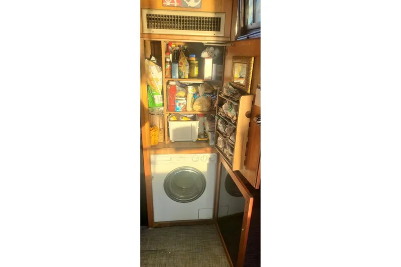 Freedom Yacht Photos Pics Laundry area with storage shelves on a 1976 Hatteras 48 Long Range Cruiser.