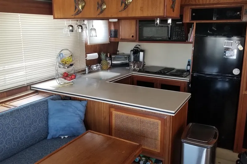 Freedom Yacht Photos Pics Interior of 1976 Hatteras 48 Long Range Cruiser with kitchen and dining area.