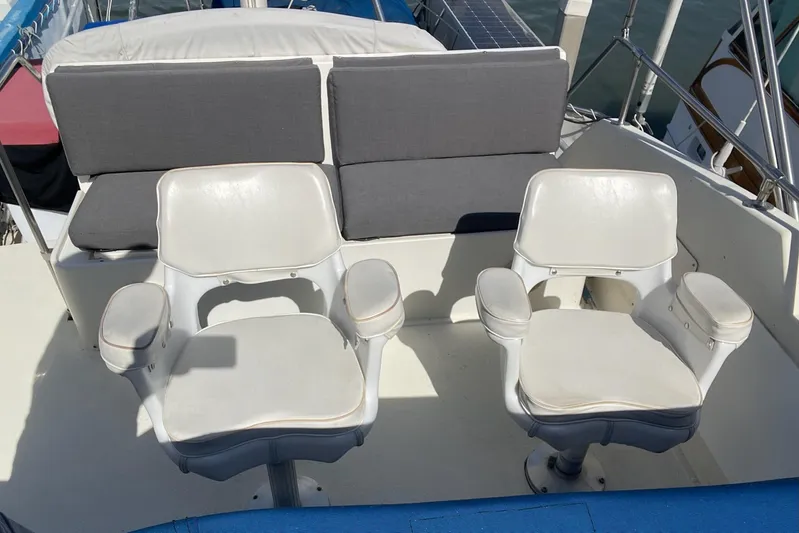 Freedom Yacht Photos Pics Two white captain chairs on a 1976 Hatteras 48 Long Range Cruiser deck.