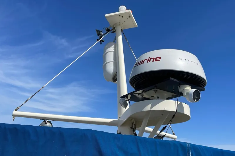 Freedom Yacht Photos Pics Radar equipment on a 1976 Hatteras 48 Long Range Cruiser against a clear blue sky.