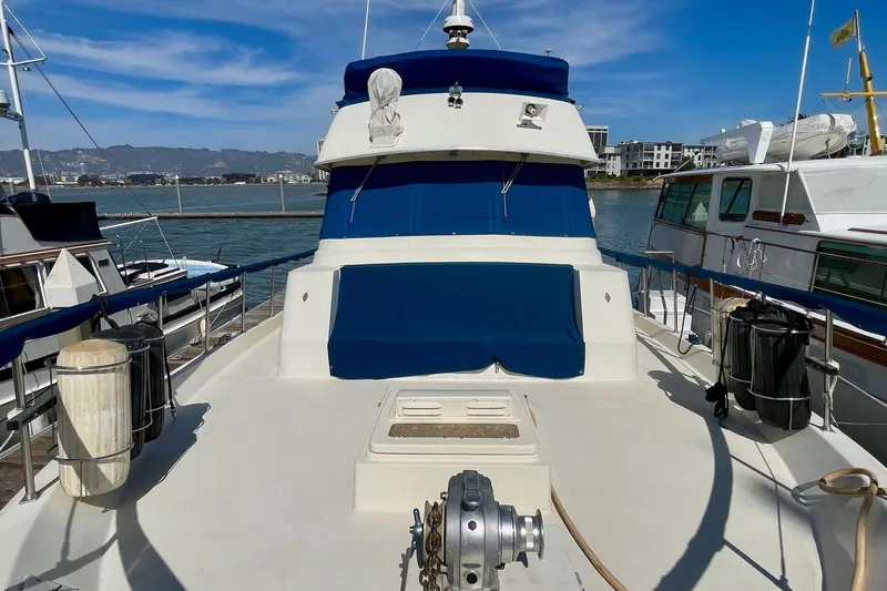 Freedom Yacht Photos Pics 1976 Hatteras 48 Long Range Cruiser docked, featuring blue and white exterior.