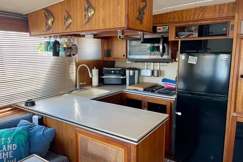 Freedom Yacht Photos Pics 1976 Hatteras 48 Long Range Cruiser kitchen with wood cabinetry and modern appliances.
