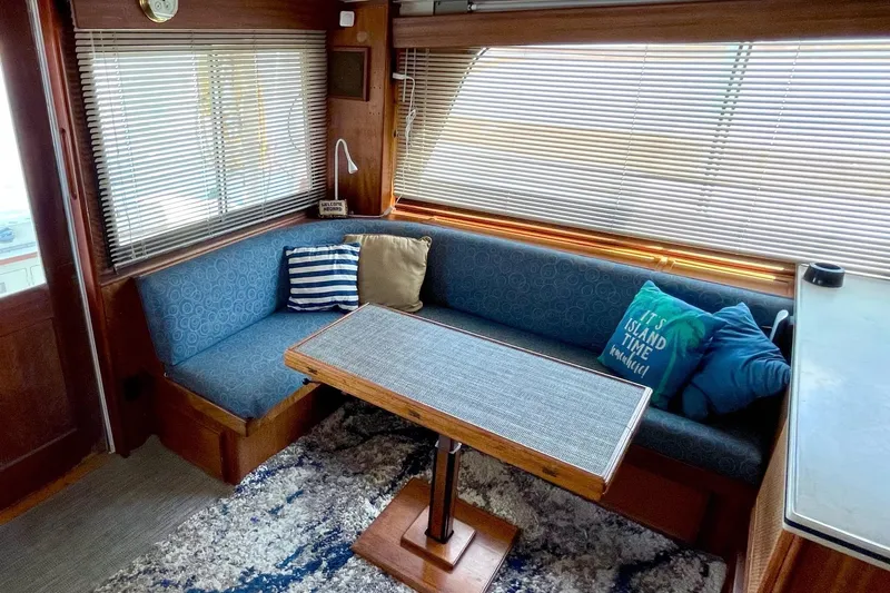 Freedom Yacht Photos Pics Interior of 1976 Hatteras 48 Long Range Cruiser with cozy seating and nautical decor.