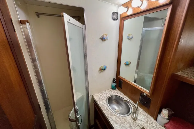 Freedom Yacht Photos Pics Bathroom interior of 1976 Hatteras 48 Long Range Cruiser with sink and shower.