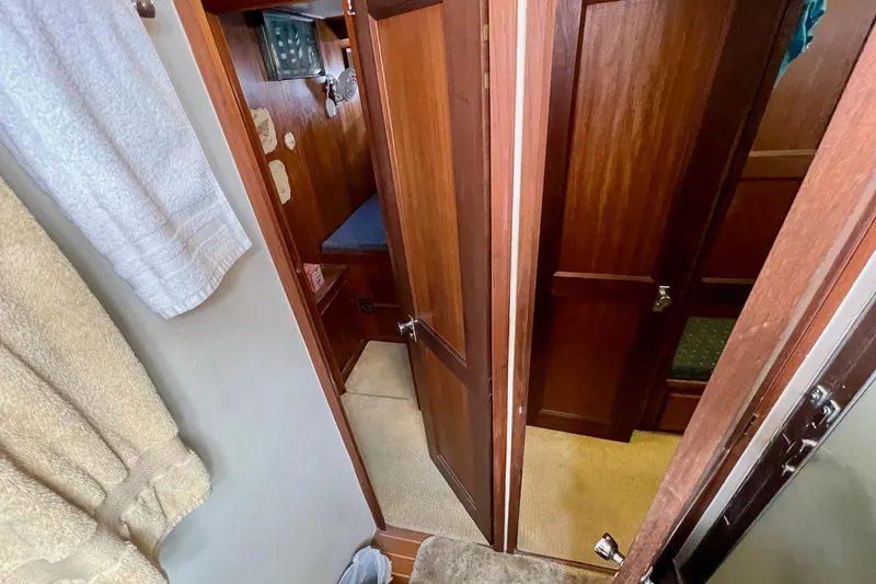 Freedom Yacht Photos Pics Interior view of 1976 Hatteras 48 Long Range Cruiser with wooden doors and cozy cabin.