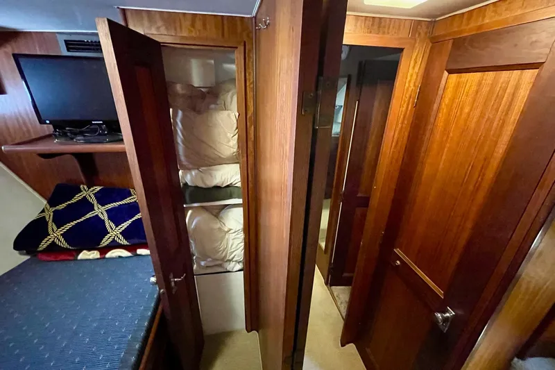 Freedom Yacht Photos Pics Interior of 1976 Hatteras 48 Long Range Cruiser with wood paneling and bunk beds.
