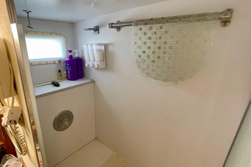 Freedom Yacht Photos Pics Bathroom interior of 1976 Hatteras 48 Long Range Cruiser with toiletries and window.