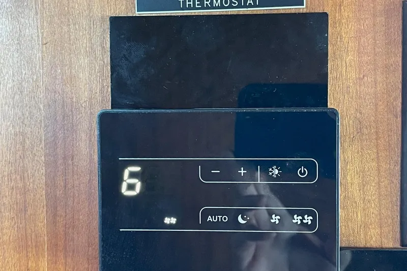Freedom Yacht Photos Pics Digital thermostat on 1976 Hatteras 48 Long Range Cruiser, displaying settings and controls.