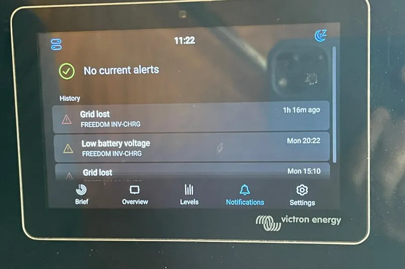 Freedom Yacht Photos Pics Victron Energy display showing alerts on a 1976 Hatteras 48 Long Range Cruiser.