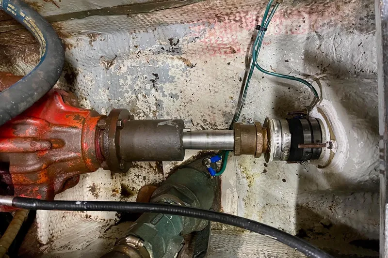 Freedom Yacht Photos Pics Engine room of 1976 Hatteras 48 Long Range Cruiser showing mechanical components and connections.