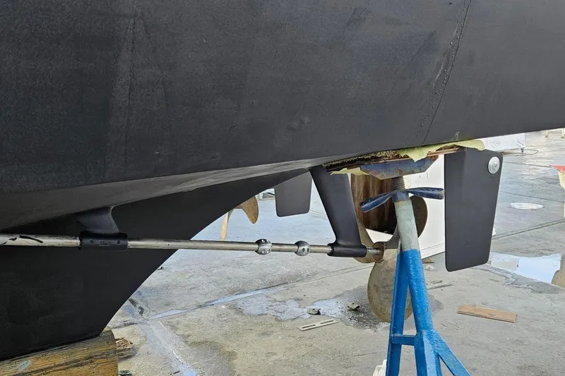 Freedom Yacht Photos Pics 1976 Hatteras 48 Long Range Cruiser hull on dry dock, showcasing propeller and rudder.