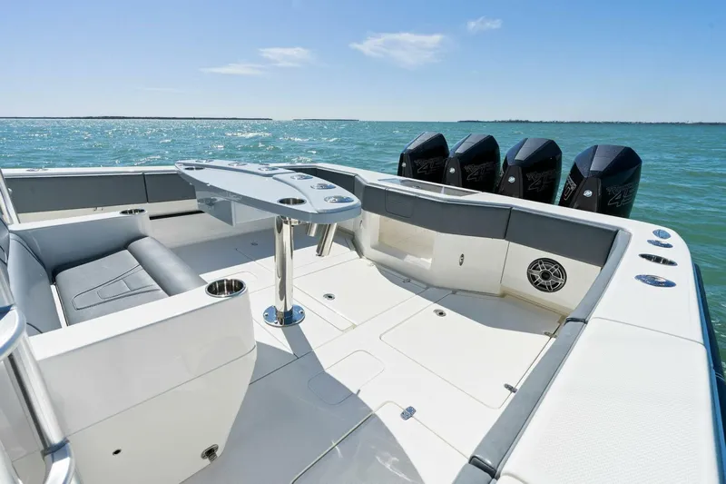  Yacht Photos Pics 2021 SeaVee 390Z boat deck with seating, table, and four outboard engines.
