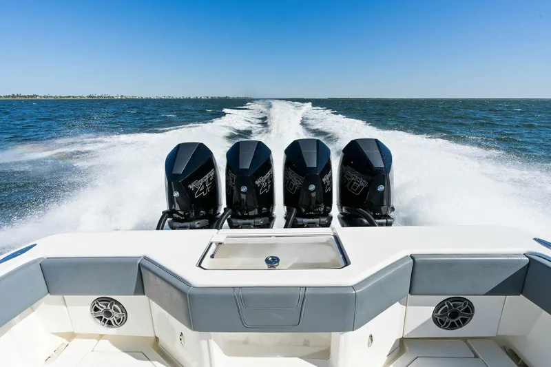  Yacht Photos Pics 2021 SeaVee 390Z boat with four powerful outboard engines cruising on open water.