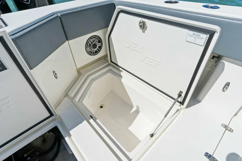  Yacht Photos Pics 2021 SeaVee 390Z boat storage compartment with open hatch and speaker.