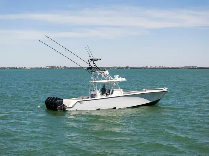  Yacht Photos Pics 2021 SeaVee 390Z boat on calm waters with fishing rods.