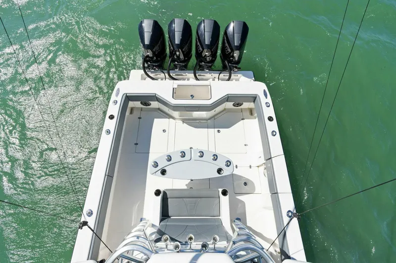  Yacht Photos Pics 2021 SeaVee 390Z boat with four powerful outboard engines on turquoise water.