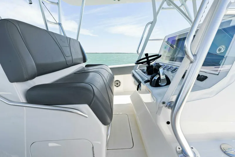  Yacht Photos Pics 2021 SeaVee 390Z boat interior with black seating and modern control panel.