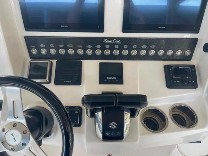  Yacht Photos Pics Control panel of 2024 Sea Cat 262 HC boat with Garmin displays and Suzuki throttle.