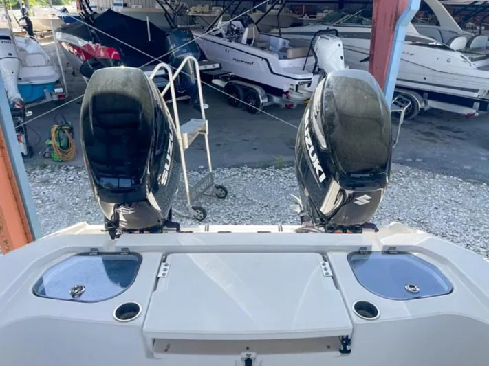  Yacht Photos Pics 2024 Sea Cat 262 HC boat with dual Suzuki outboard motors in a marina.