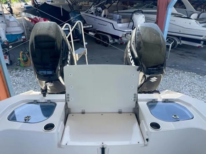  Yacht Photos Pics 2024 Sea Cat 262 HC boat with dual outboard motors in a marina.
