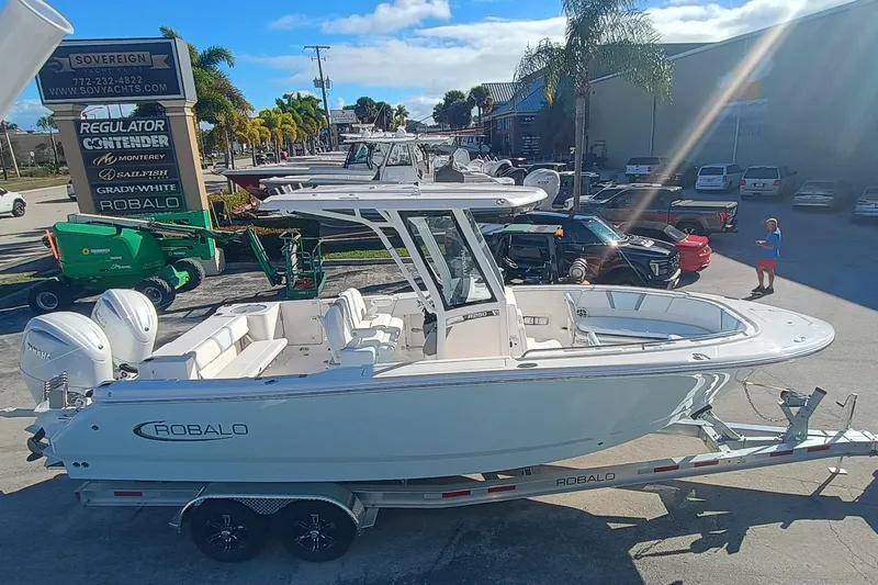 250-118 Yacht Photos Pics 2026 Robalo R250 Center Console boat on trailer, outdoor dealership display.