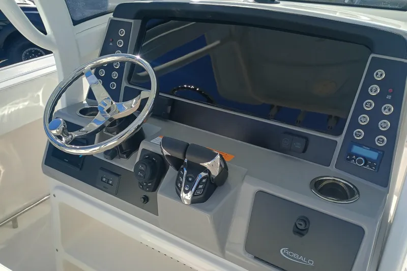 250-118 Yacht Photos Pics 2026 Robalo R250 Center Console boat dashboard with steering wheel and controls.