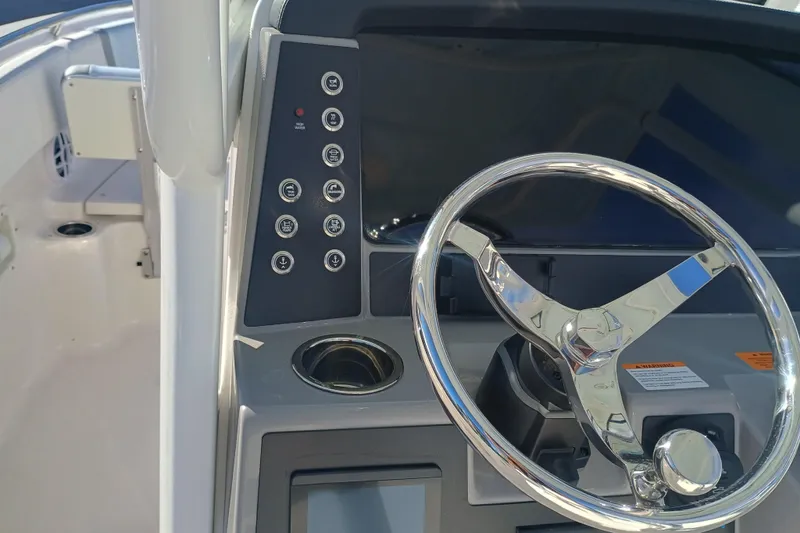 250-118 Yacht Photos Pics 2026 Robalo R250 Center Console boat dashboard with steering wheel and control panel.