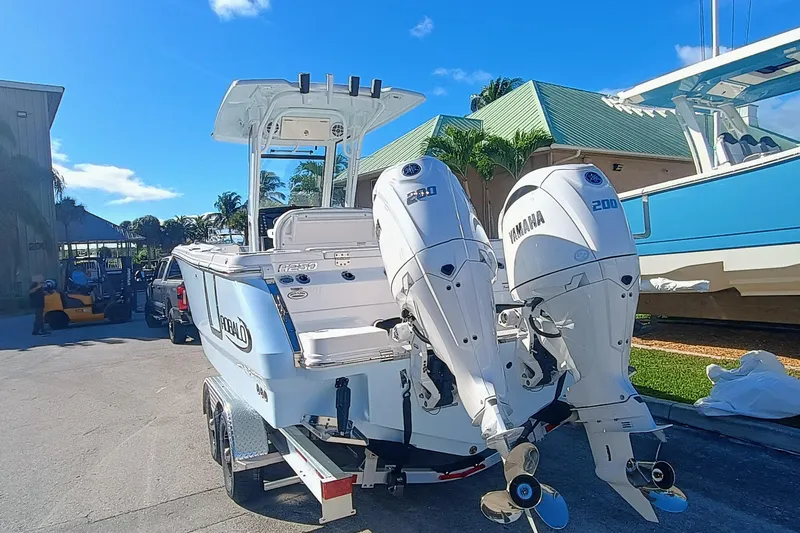 250-118 Yacht Photos Pics 2026 Robalo R250 Center Console boat with twin Yamaha engines on a trailer.