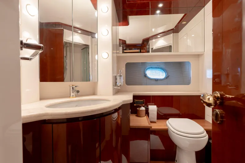 Cool Running Yacht Photos Pics Luxurious bathroom interior of 2003 Mochi Craft 22.5 Axis yacht with elegant wood finishes.