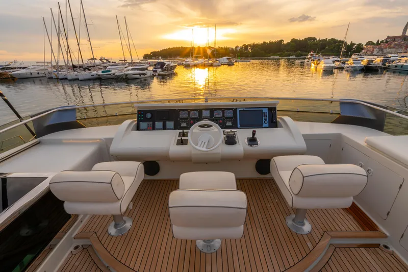 Cool Running Yacht Photos Pics Luxurious Mochi Craft 22.5 Axis yacht helm, 2003 model, with sunset marina view.