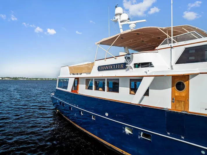 Chanticleer Yacht Photos Pics Classic 1973 Burger 310C yacht on water, blue hull, clear sky background.