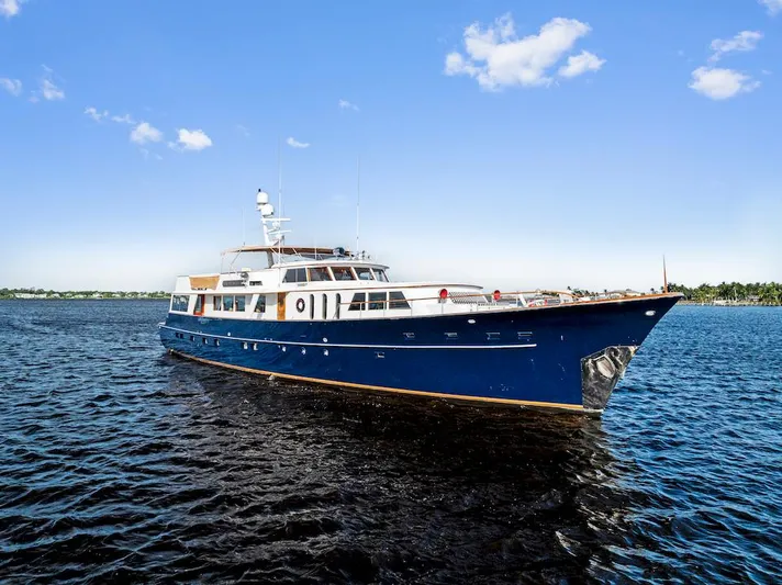 Chanticleer Yacht Photos Pics Classic 1973 Burger 310C yacht cruising on a sunny day with clear blue skies.