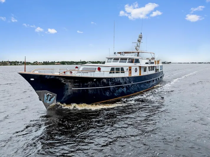 Chanticleer Yacht Photos Pics Classic 1973 Burger 310C yacht cruising on open water under a clear blue sky.
