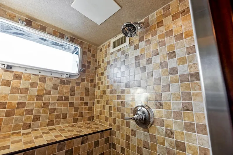 Chanticleer Yacht Photos Pics Shower with beige mosaic tiles and chrome fixtures in a 1973 Burger 310C.