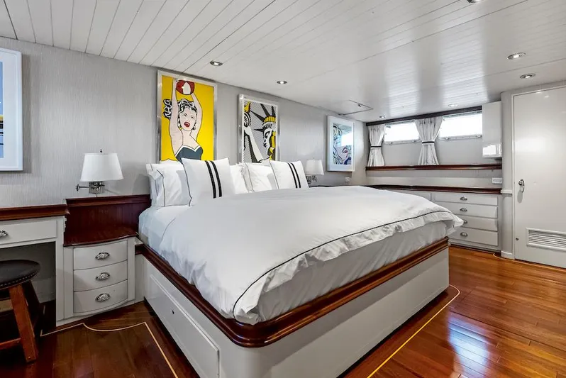 Chanticleer Yacht Photos Pics Luxurious yacht bedroom with modern art, wood flooring, and elegant bedding, 1973 Burger 310C model.