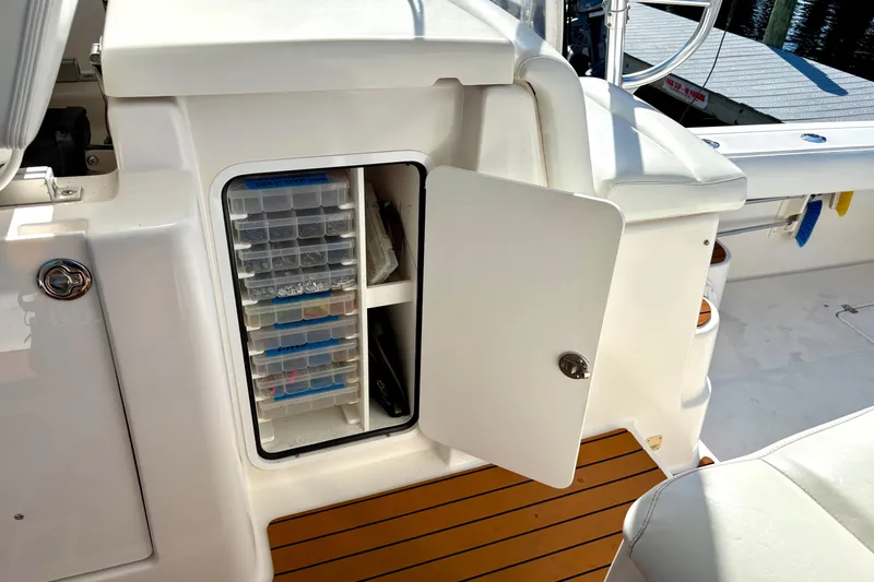 Kinja Yacht Photos Pics Open storage compartment on 2002 Pursuit 3800 Express boat with organized tackle boxes.
