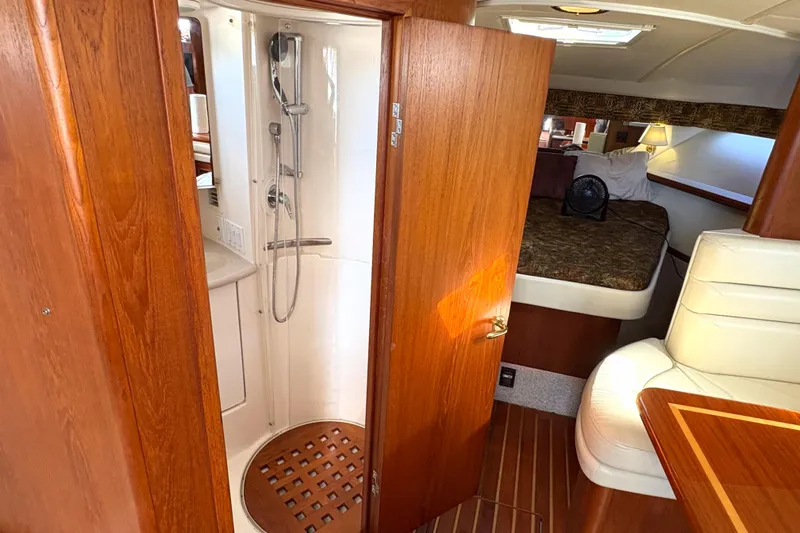 Kinja Yacht Photos Pics 2002 Pursuit 3800 Express yacht interior with shower, bed, and seating area.