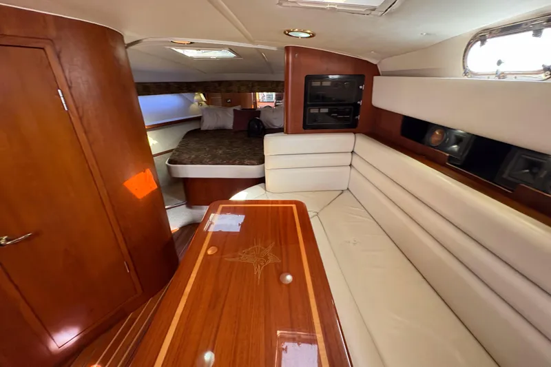 Kinja Yacht Photos Pics Luxurious interior of a 2002 Pursuit 3800 Express yacht with wood and leather finishes.