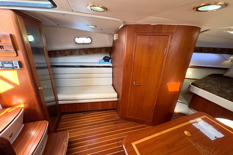 Kinja Yacht Photos Pics Interior of 2002 Pursuit 3800 Express yacht with wood finish and seating area.