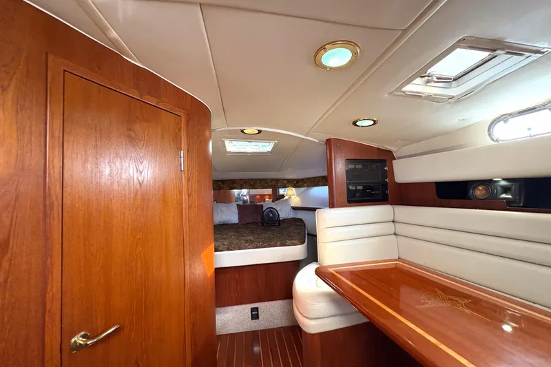Kinja Yacht Photos Pics Luxurious interior of 2002 Pursuit 3800 Express yacht with wood finishes and cozy seating.