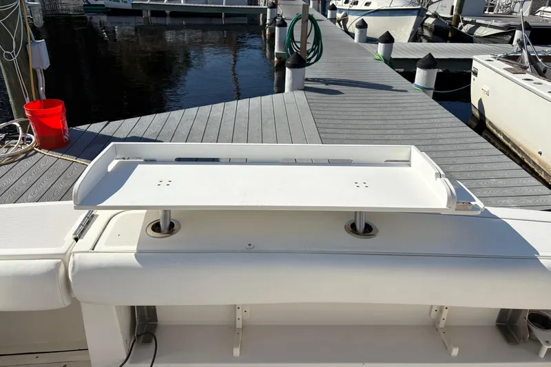 Kinja Yacht Photos Pics 2002 Pursuit 3800 Express boat at dock with white deck and fishing station.