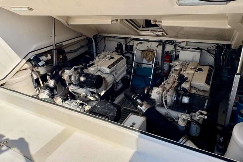 Kinja Yacht Photos Pics Engine room of a 2002 Pursuit 3800 Express boat, showcasing dual engines and equipment.
