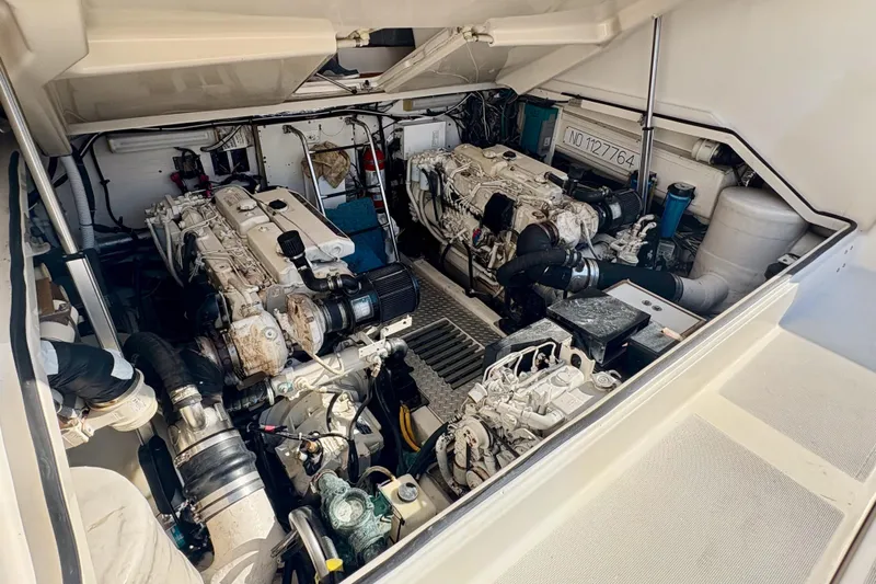 Kinja Yacht Photos Pics Engine room of a 2002 Pursuit 3800 Express boat, showcasing dual engines.