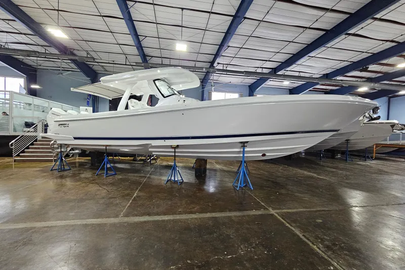  Yacht Photos Pics 2026 Intrepid 375 Nomad SE boat displayed indoors on stands.