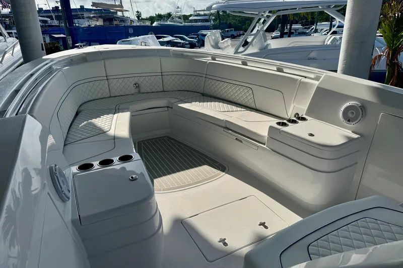  Yacht Photos Pics Luxurious seating area on 2026 Intrepid 375 Nomad SE boat, featuring elegant design and cup holders.