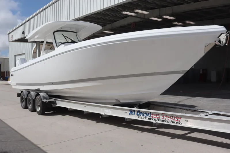  Yacht Photos Pics 2026 Intrepid 375 Nomad SE boat on trailer outside a warehouse.